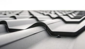 Home Close-up view of a metal roof's wavy design showcasing rivets and structural detail.